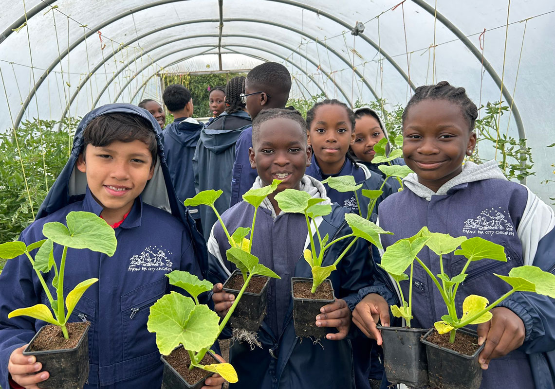 Group of children holding plants