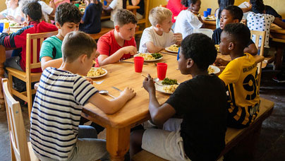 Children eating together in a dining room
