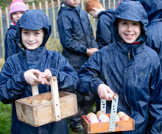Children holding baskets of eggs