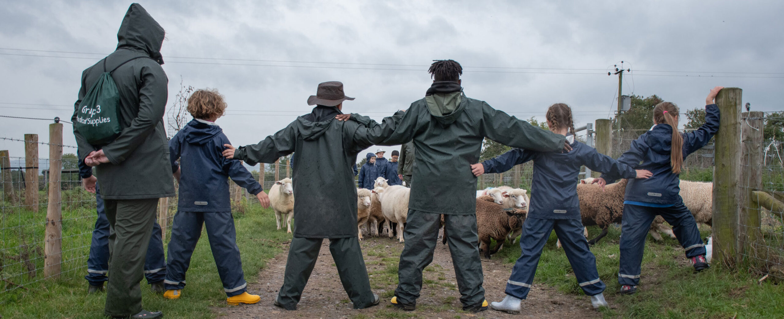 Children forming barrier to herd sheep